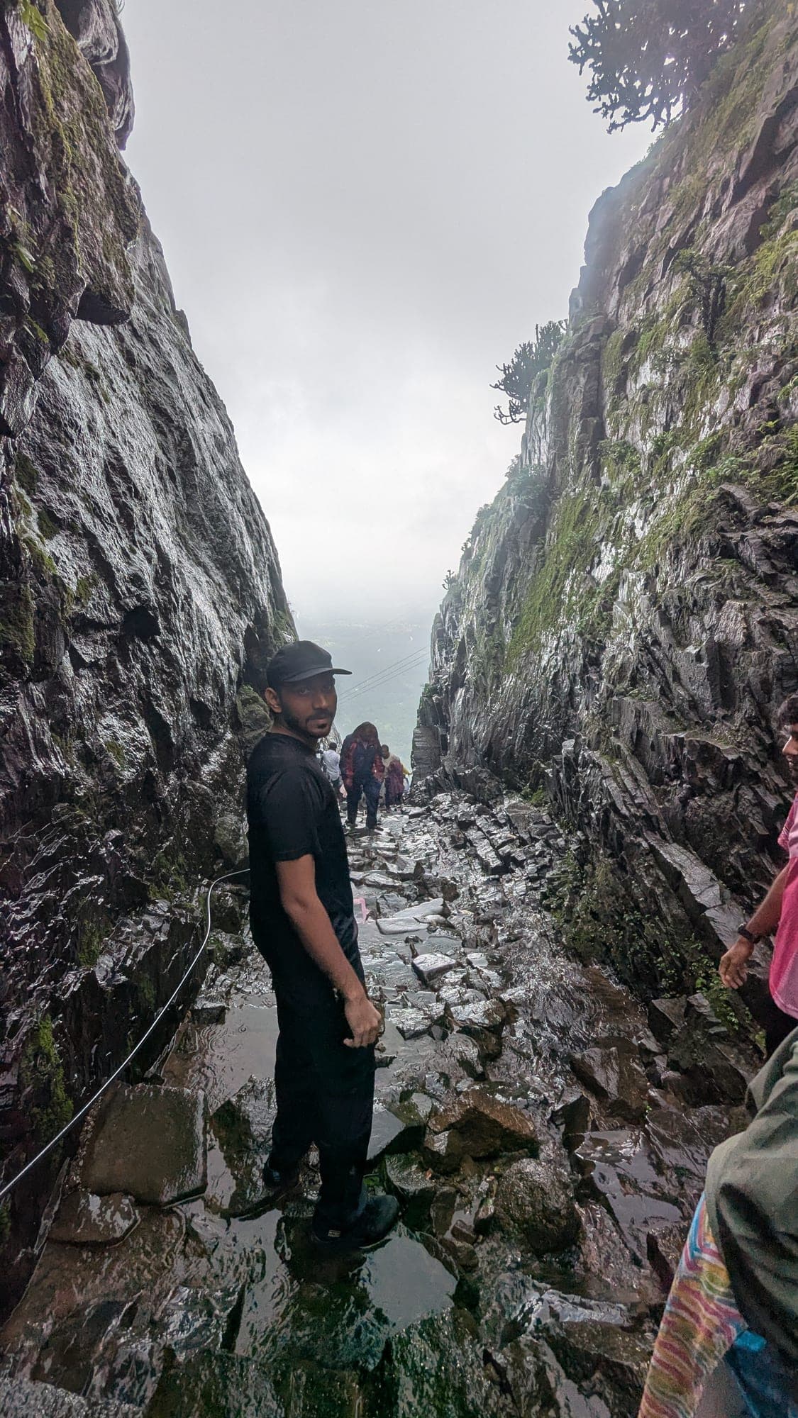 Trekkers descending through the narrow rock-cut Naneghat pass